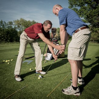 Bob Collins working on a student's grip and setup